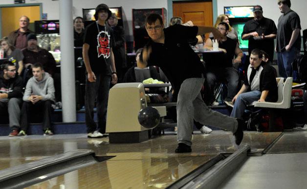 Marysville Arts & Technology captain Eli Reed thrusts a bowling ball down the lane during his team's league match at Strawberry Lanes on Nov. 18.