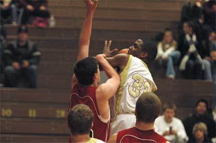 Junior Tre’ Haslom absorbs the defense’s contact and makes the basket while being fouled.