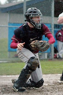 Catcher Michael Leach rises quickly while thinking about a snap throw to first.