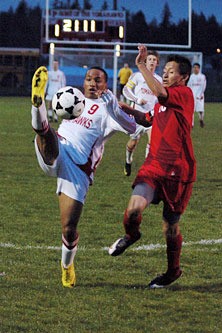 John Crenshaw controls a pass over his shoulder inside the penalty box.