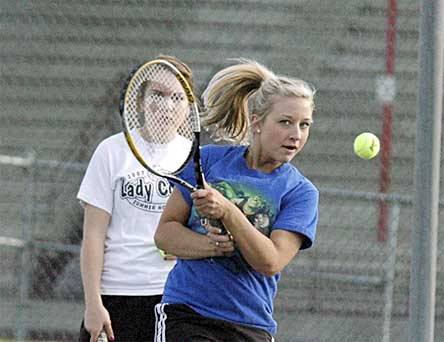 Doubles player Darcie Ness practices her backhand.