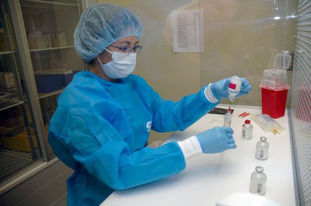 Pharmacists such as Hau Dong mix the chemotherapy drugs just down the hall from where the patients receive their treatments