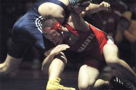 Senior 171-pounder Cole Cushing tries to break loose of opponent Hayden Love's grip.