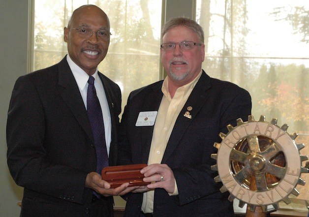 Snohomish County Executive John Lovick receives a pen from Marysville Rotary President Daryn Bundy during his visit to their club on Oct. 30.