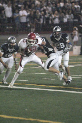 M-P senior wide receiver Josh Kinnard focuses on holding the ball as defenders swarm him. The Tomahawks stayed a perfect 3-0 as they visited Glacier Peak.