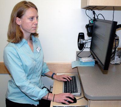 Dr. Katie Dunbar checks patients’ medical records electronically at the Community Health Center of Snohomish County in Everett.