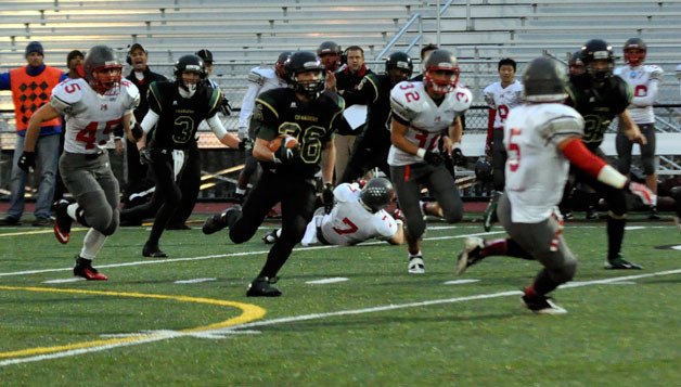 Marysville Getchell’s Wil Owens runs the ball against a pack of Hawks during their Oct. 26 home game.