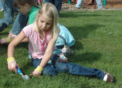 Marysville's Madelyn Teerlink shoveled weeds out of the grass at Jennings Park as part of last year's National Day of Service and Remembrance.