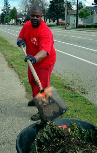 Ray Lewis of Keller Williams Realty in Marysville clears off the sidewalks around the Rudy Wright Memorial Field on May 12.