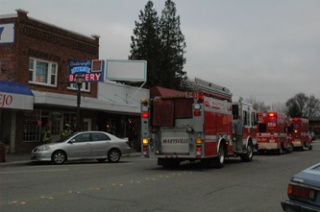 Emergency response vehicles park on Third Street next to Oosterwyk's Dutch Bakery