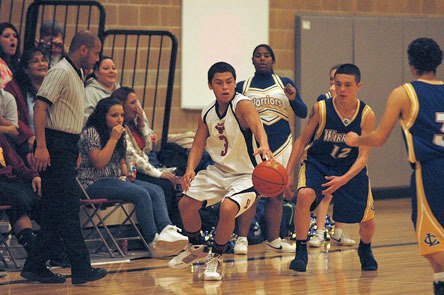 Sophomore guard Izzy Enick hustles to recover a loose ball from Chief Leschi. Enick scored seven points.