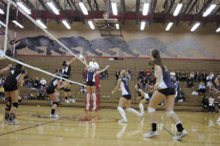 Arlington setter Kelsey Czaban hopes to catch Snohomish off guard by tipping the ball over the net.