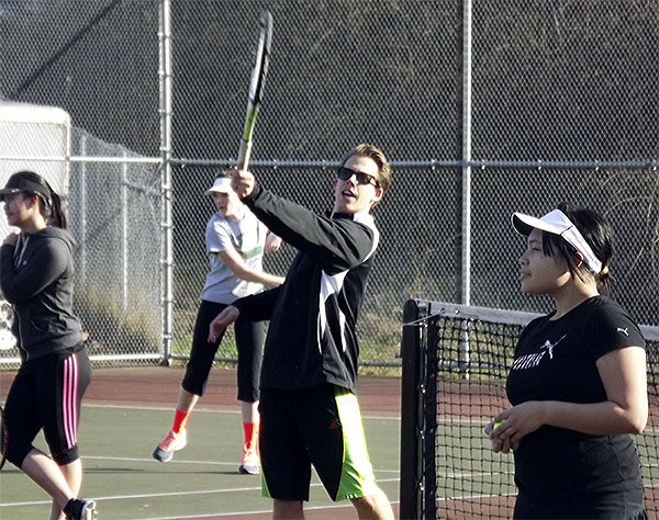 MG Coach Andrew Christopher shows the girls team how to finish high across the body to put topspin on the ball and keep it in play.