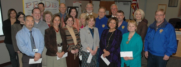 Principals from Marysville elementary schools stand with Marysville School Board members and the Marysville Rotarians from whom they received a total of $14