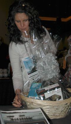 Melissa Morris of Snohomish checks out a travel basket up for bid in the Tulalip Resort Hotel.