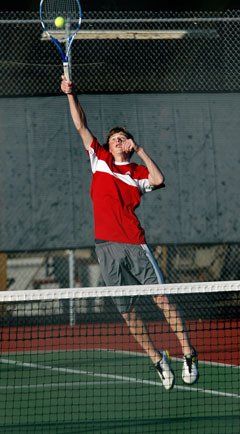 M-P junior Chris Rasmussen spikes down a point in the Wesco North championship doubles match.