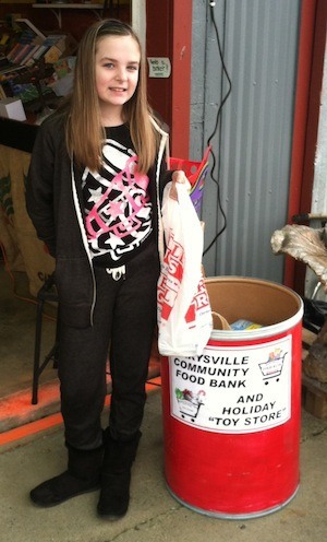 Fallyn Gentry collects for the Marysville Community Food Bank at the Dues Produce Barn on March 15.