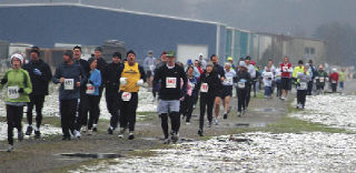 One hundred and two runners crossed the finish line in the Arlington Runners Club’s Toys for Tots run in the first snowfall Dec. 13. They collected toys and cash donations as well as running 5 and 10K races.