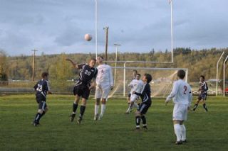 M-P senior forward Jordan Salcedo wins a battle in the air against Arlington midfielder Eric Love.