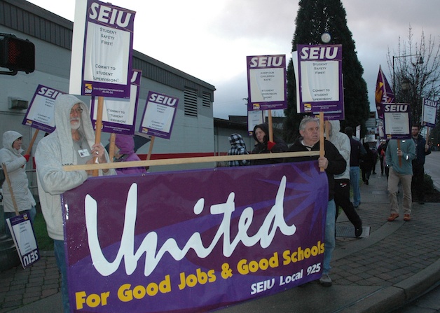 Members of Service Employees International Union Local 925 picket outside Totem Middle School on the morning of Dec. 14.