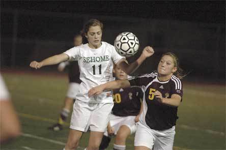 Lakewood freshman Abby Burke fights with a Sehome player for possession Nov. 3. Burke scored the winning goal against Burlington-Edison in overtime Nov. 7.