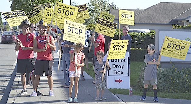 Firefighters and their family members picket outside Marysville City Hall this evening prior to the City Council meeting. The firefighters are urging the city to form a Regional Fire Authority