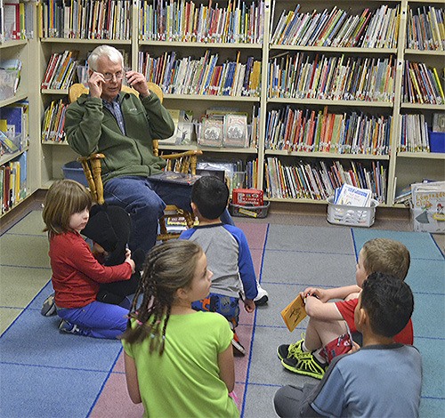 Kellogg Marsh Elementary School custodian talks to students after reading a book to them at the school's 'Snuggle Up and Read' event March 8.