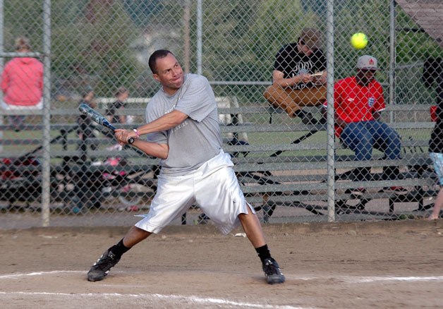 Randy’s Light Construction’s Aaron Taylor takes aim at pitch during the team’s victory over the Slackers in a Marysville coed softball game