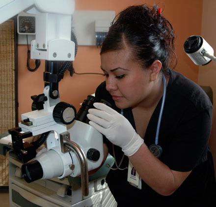 Marysville Sea Mar medical assistant Gricelda Paz checks the colposcope machine before it’s used on any patients.