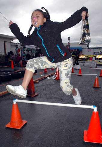 Dionna Samuels clears three hurdles in a row as part of the April 16 Fit-Tastic Easter Egg Hunt on Third Street.