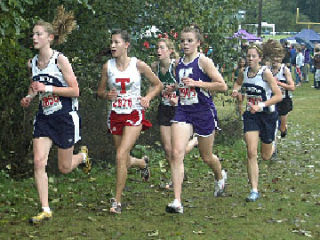 Arlington sophomore Bryna Prause leads a small pack as the 4A girls approach the mile marker at South Whidbey. Teammate Kristin Wreggelsworth is just a few strides behind. The girls finished seven seconds and two places apart