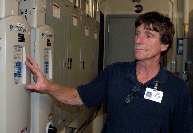 Marysville Getchell High School custodian Michael Mitchell checks one of the variable frequency drives that’s part of the Marysville Getchell High School campus’ energy efficiency features.