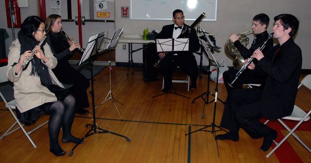 Members of the Everett Youth Symphony practice before performing on stage at the Marysville Sea Mar Community Health Center’s holiday party Dec. 18 at Cedarcrest Middle School.