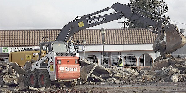 A bulldozer continues to tear down the Old Country Buffet restaurant at 4th and State in Marysville. Coastal Community Bank will take its place.