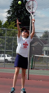 Marysville junior tennis team’s Cassandre Valles practices her serve against a teammate