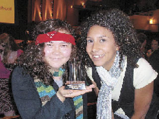 Roxanne Franck and Erica Ewell accept an award June 9 for Best Hair and Makeup Design on behalf of the crew at Arlington High School who worked on the musical