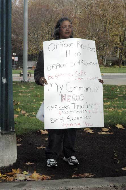 Seattle resident Leila Martinez holds a sign in honor of slain Seattle Police Officer Timothy Brenton outside the Key Arena in Seattle Nov. 6.