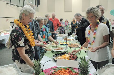 Attendees line up almost out the door of the Smokey Point Community Church June 26 to sample the buffet selections at the Village Community Services Taste of Decadence fundraiser.