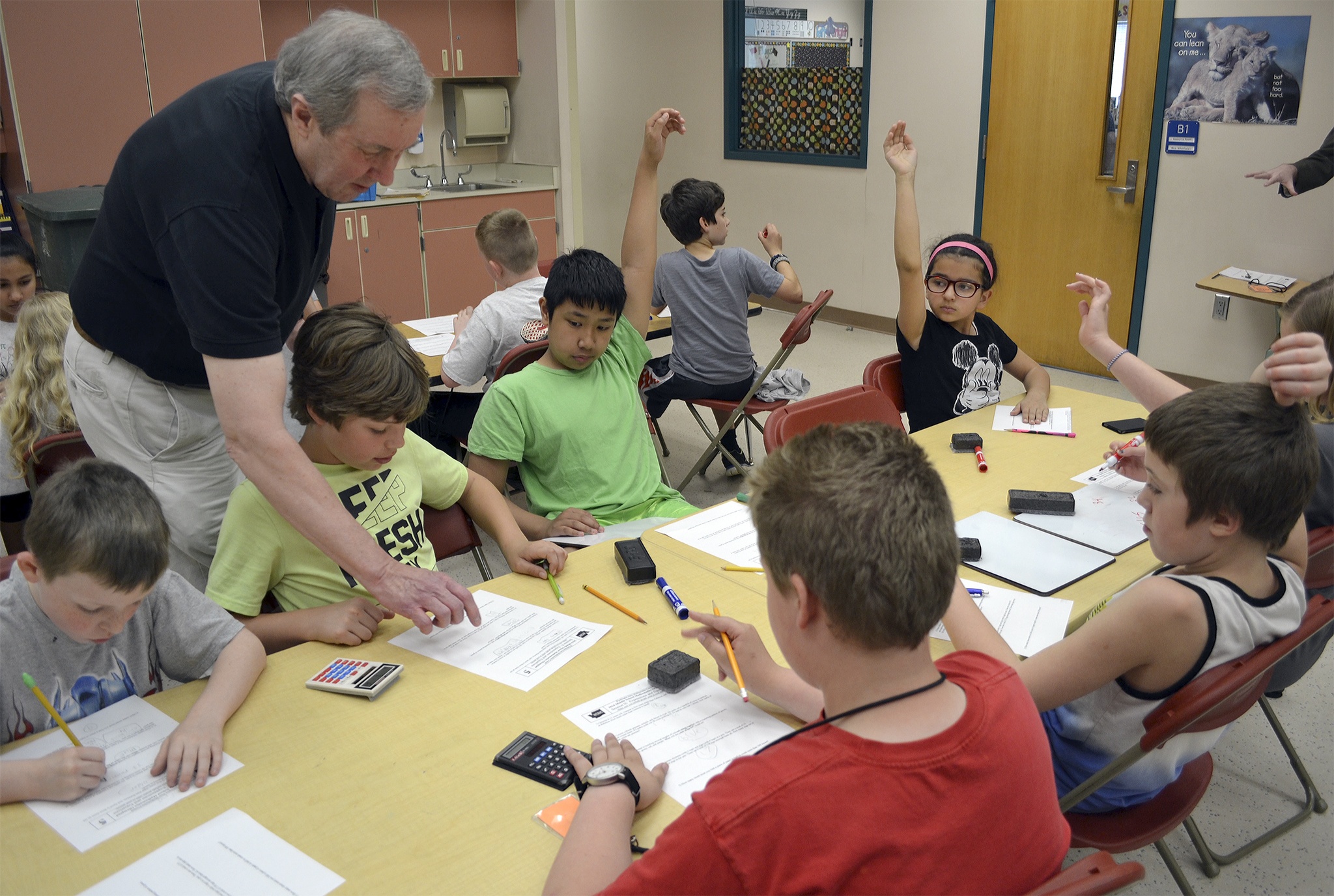 Steve Powell/Staff PhotoMath Olympiad coach John Bloom helps 16 Kellogg-Marsh Elementary School third-through-fifth grade students during a recent practice session. The team recently placed at state in its first year of the competition