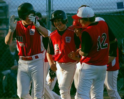 Marysville all-star slugger Jarred Wade is congratulated by his teammates in the third inning