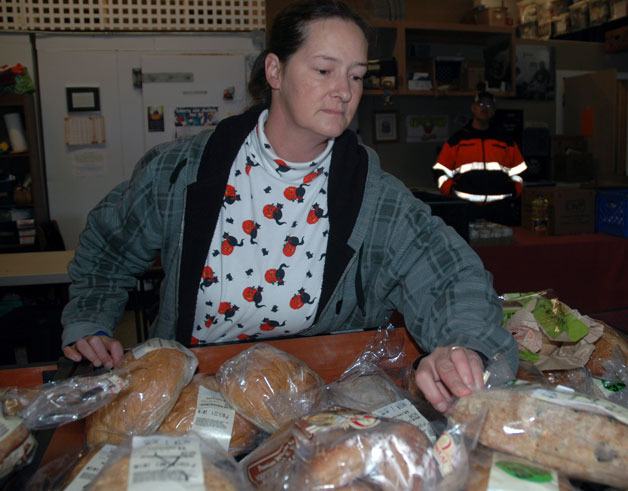 Rebecca Read browses through the bread selection at the Seeds of Grace Distribution Center’s food bank.