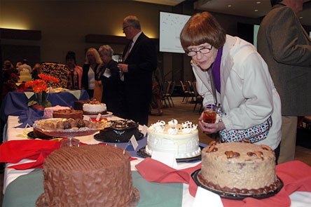 Marysville’s Shari Petersen sees money as no object when shopping for cakes at a silent auction in support of victims of domestic violence.