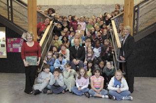 The students and teachers of three classes at Grove Elementary School pose with Washington’s “Fire Gentleman