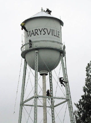 Marysville firefighters work Nov. 29 to prepare the water tower lights for the Merrysville Electric Lights Parade Dec. 6.