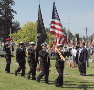 The Marysville-Pilchuck High School Naval Junior ROTC Color Guard parades the colors to open the May 25 observance of Memorial Day ceremony at Marysville Cemetery.