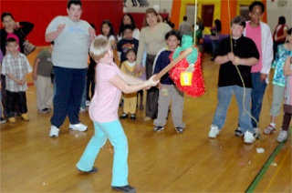 Jamison Strickland takes a whack at a pinata in the Totem Middle School gymnasium May 8.