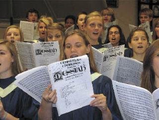 Arlington High School choral students warm up for the upcoming community choir’s presentation of Handel’s “Messiah” set for Dec. 14. Choir director Lyle Forde has announced a call for singers from the community.