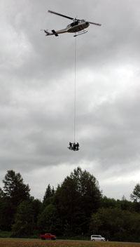 Members of the Snohomish County Sheriff’s Office Air Support Unit demonstrate a flight-and-rescue set of maneuvers near the Tulalip Resort using the Snohomish County Helicopter SnoHawk 10 and the Airborne Tactical Extraction Platform on June 14.