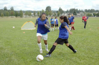 Sophomore midfielder Krista Riozzi duels a teammate for the ball during practice.