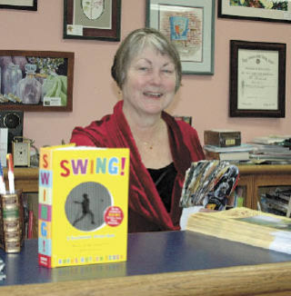 BookWorks owner Mary Burns shows titles “Swing” and “Star Wars” that she expects to be popular among gift-givers this season.